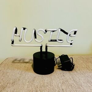White Neon 'Hustle' Sign with Black Base